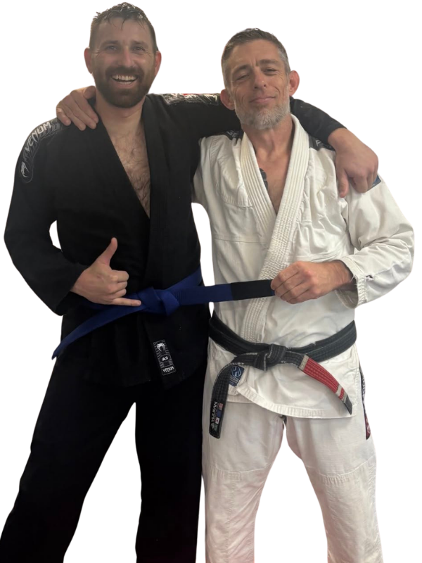 Two adult Elevate Martial Arts students celebrating a Brazilian Jiu Jitsu belt promotion