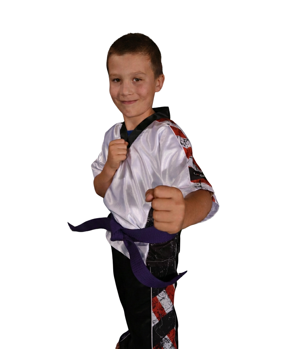 Young Dragons student in a white and black uniform with a purple belt in a fighting stance