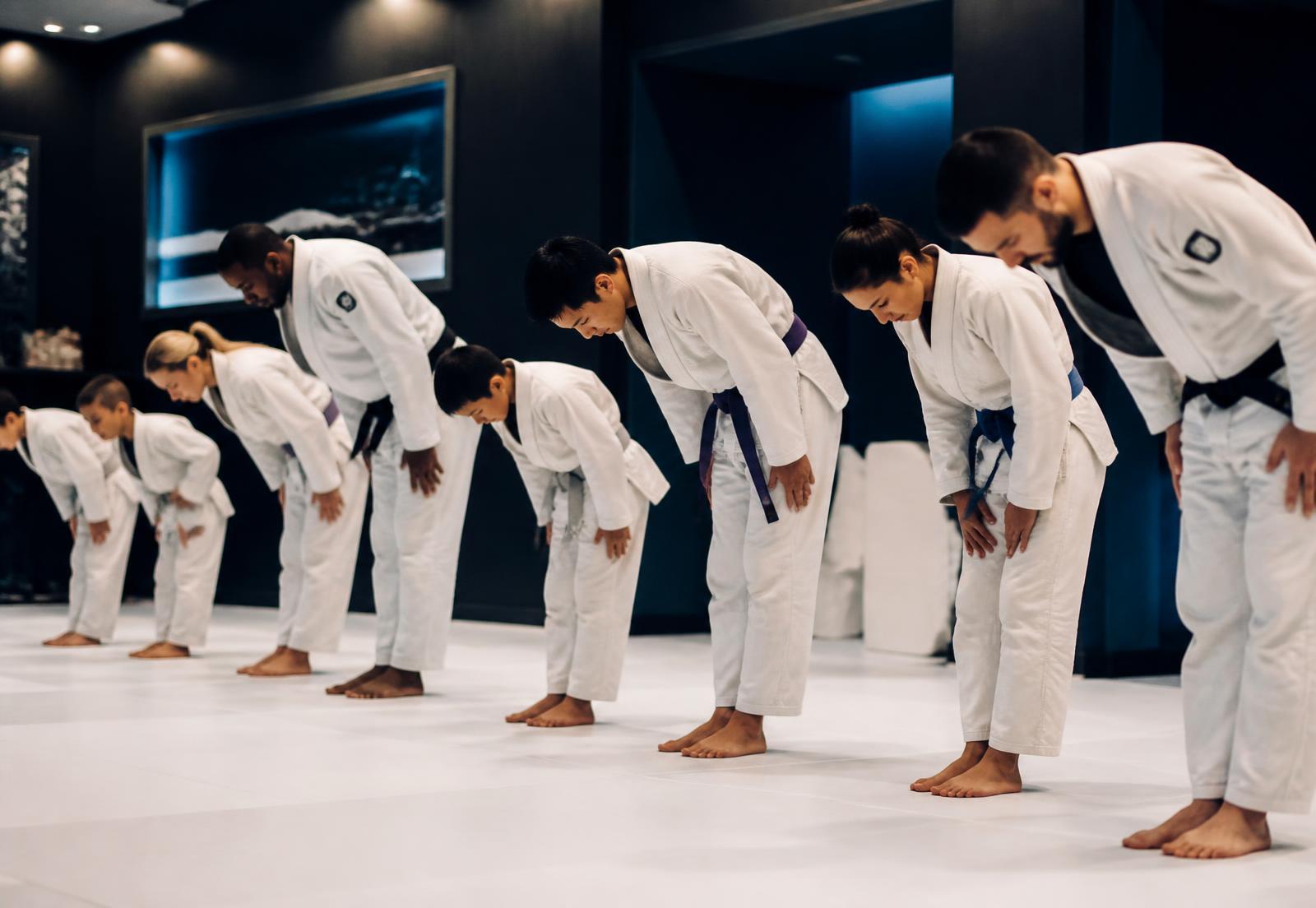 Students of all ages bowing at the start of a class at Elevate Martial Arts